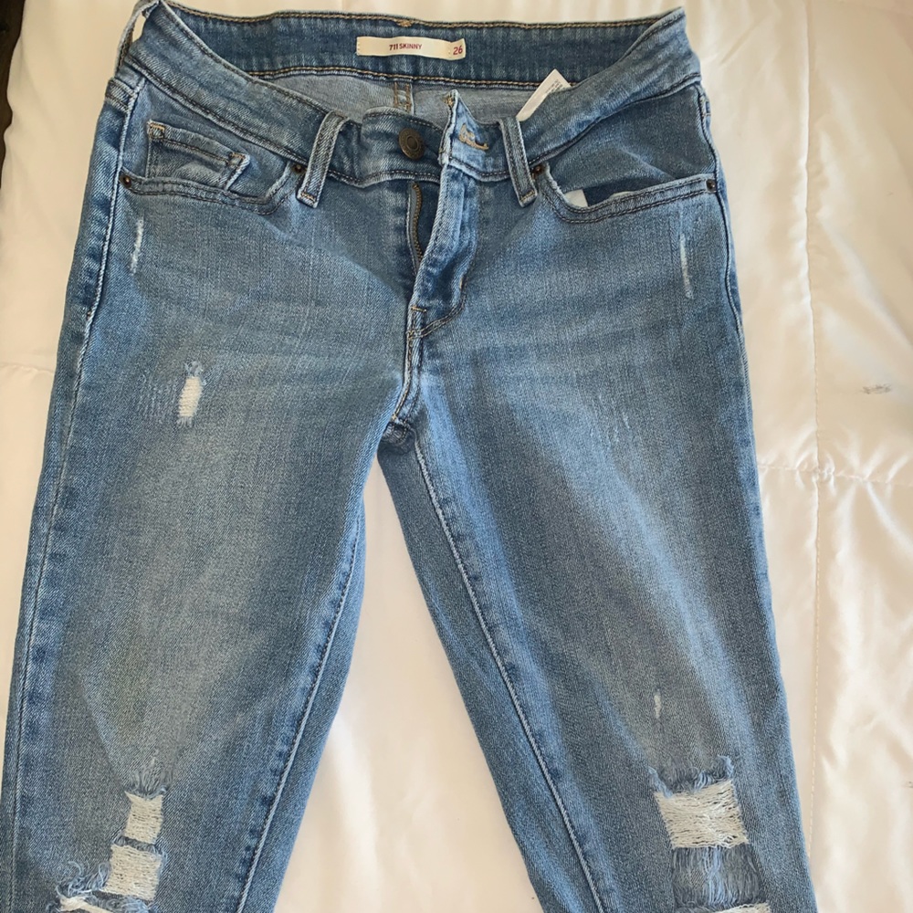 Two pairs of distressed 711 Levi’s.